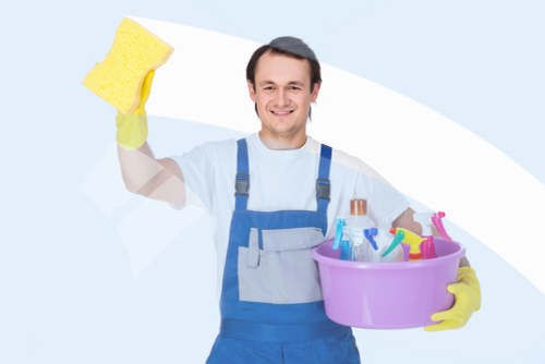 Happy customer receiving cleaned clothes from Arnos Grove Cleaners